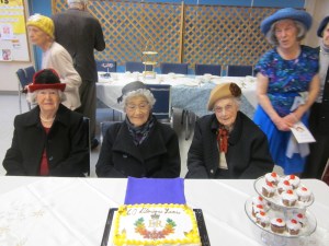 Group picture around Jubilee cake